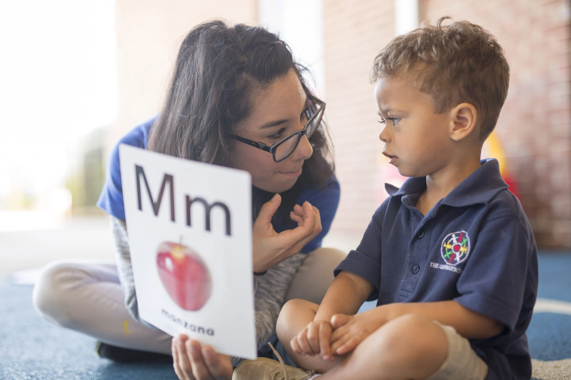 Teacher helping a child learn letters at The Gardner School