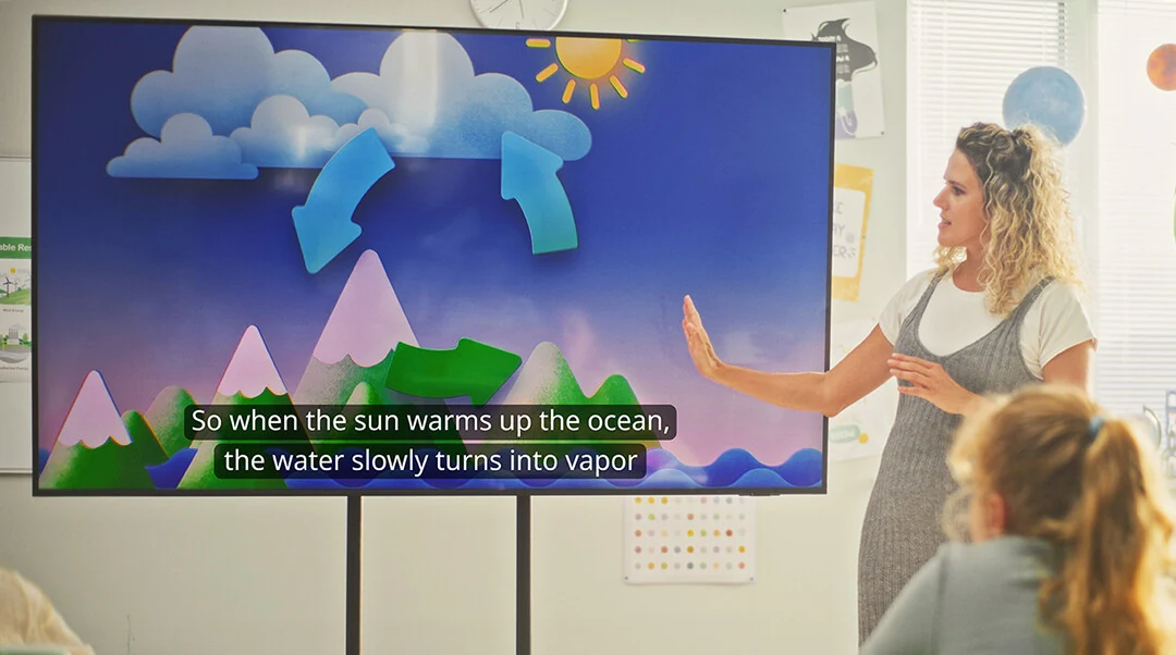 Teacher using a classroom display with Vivi live captions